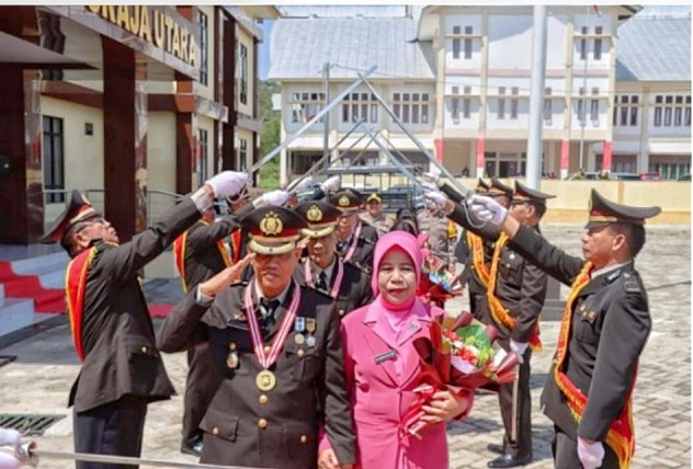 PENSIUN -- Kapolres Torut AKBP Zulanda memimpin pedang pora pelepasan lima anggota Polri yang telah masuk masa purna bakti