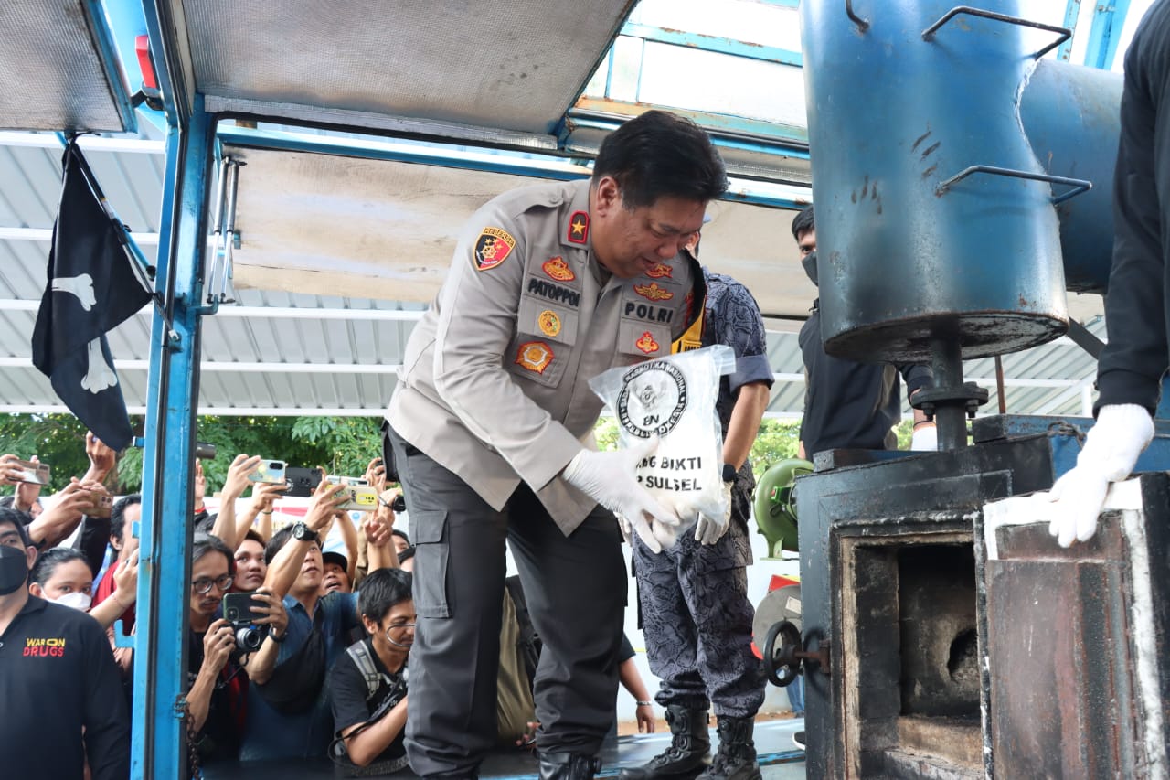 PEMUSNAHAN -- Wakapolda Sulsel, Brigjen Pol Chuzaini Patoppoi, saat akan melakukan pemusnahan barang bukti Narkoba dengan memasukkan ke dalam tungku yang telah dipersiapkan.
