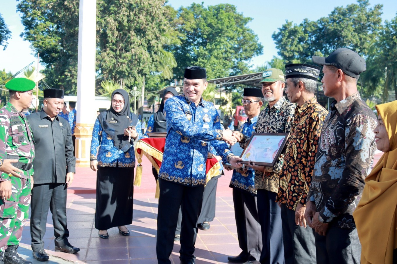 PIAGAM PENGHARGAAN -- Sekkab Takalar, H Muh Hasbi menyerahkan piagam penghargaan kepada masyarakat atas kontribusinya sebagai tuan rumah pemondokan kafilah MTQ ke-XXXIII tingkat Provinsi Sulawesi Selatan tahun 2024.