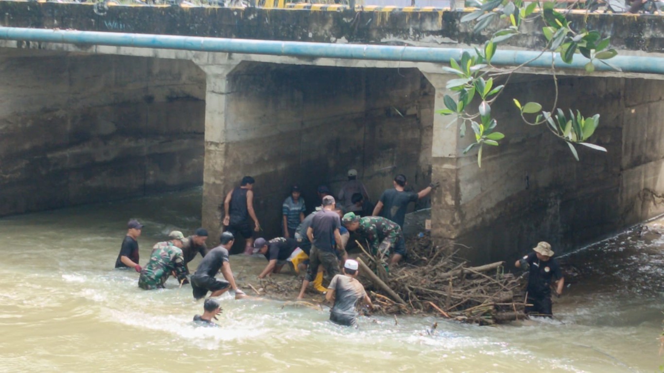 BERSIHKAN -- Personel Koramil 1403-01/Larompong melaksanakan Karya Bakti TNI bergotong royong pembersihan sampah sisa material banjir yang menumpuk di Kolong Jembatan Keppe, Desa Rante Belu, Kecamatan Larompong, Kabupaten Luwu, Senin (27/5)
