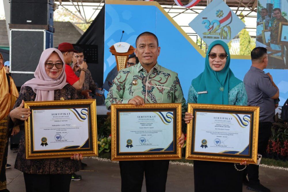 PENGHARGAAN -- Bupati Luwu Timur, H. Irwan Bachri Syam, Wabup Hj Puspawati Husler dan Ketua TP PKK Luwu Timur, Ani Nurbani Irwan foto bersama usai menerima penghargaan dari Menteri Kemendukbangga RI Wihaji  disela-sela memperingati Hari Keluarga Nasional (Harganas) di Lapangan Karebosi, Makassar baru-baru ini. 
