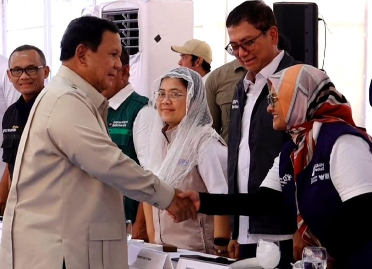 JABAT TANGAN -- Direktur Utama Telkom, Dian Siswarini (kanan) berjabat tangan dengan Presiden Republik Indonesia (RI), Prabowo Subianto (kiri), pada agenda Kunjungan Kerja ke Aceh Tamiang dalam rangka meninjau secara langsung Hunian Danantara (Huntara) yang diperuntukkan bagi masyarakat terdampak banjir, pada Kamis, 1 Januari 2026.